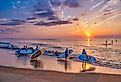 A group of young women take their paddle boards out at sunrise to paddle along the Atlantic Coast. Image credit David Kay via Shutterstock
